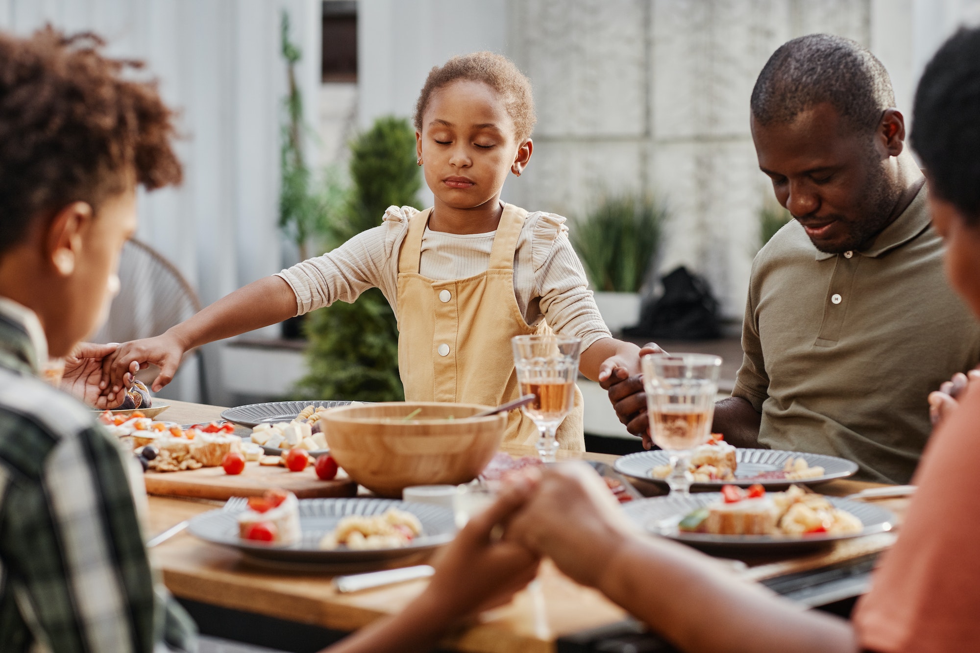 Family Praying at Dinner